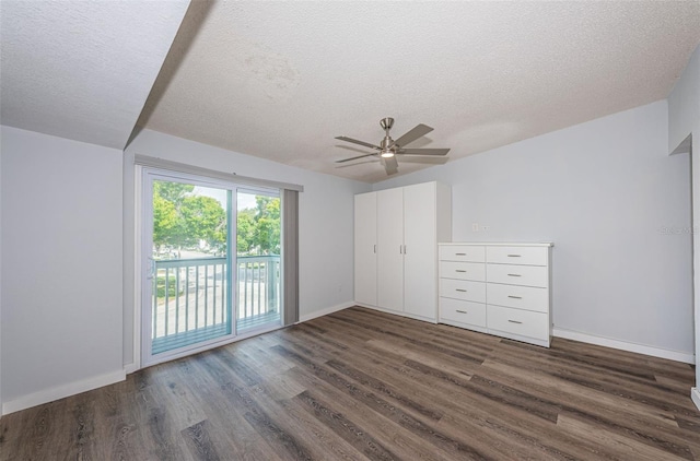 6206 92nd Pl N Unit 3605, Pinellas Park, FL 33782 - unfurnished bedroom featuring access to exterior, dark wood-type flooring, a textured ceiling, and ceiling fan
