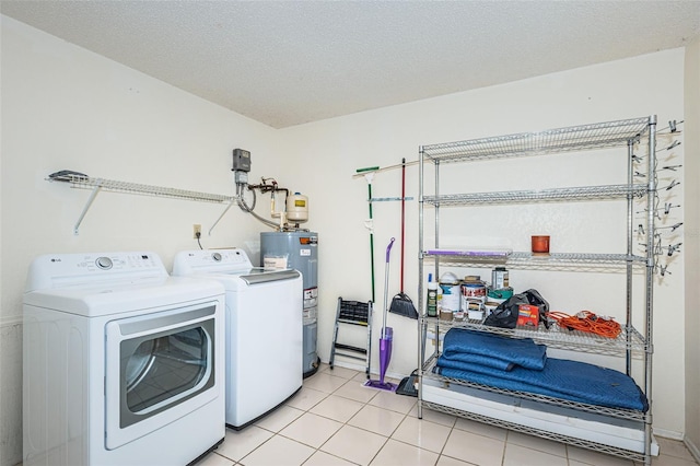6206 92nd Pl N Unit 3605, Pinellas Park, FL 33782 - laundry room with water heater, independent washer and dryer, light tile patterned floors, and a textured ceiling