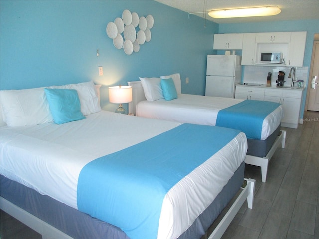 9980 Gulf Blvd Unit 408, Treasure Island, FL 33706 - bedroom with freestanding refrigerator and wood finished floors
