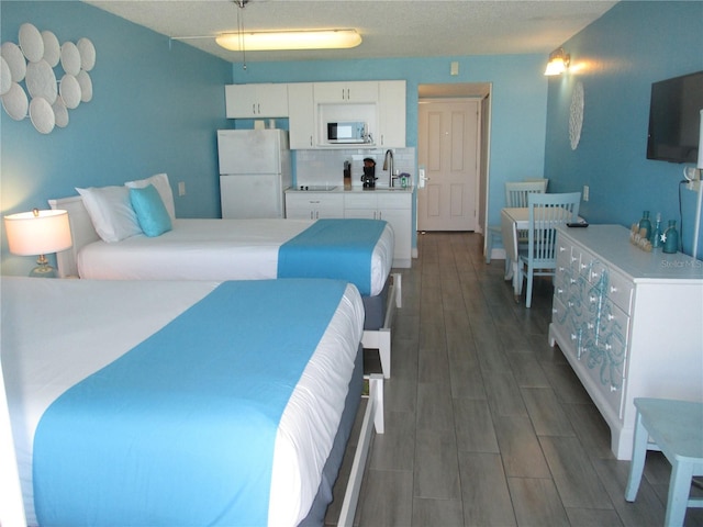 9980 Gulf Blvd Unit 408, Treasure Island, FL 33706 - bedroom featuring freestanding refrigerator and dark wood-style flooring