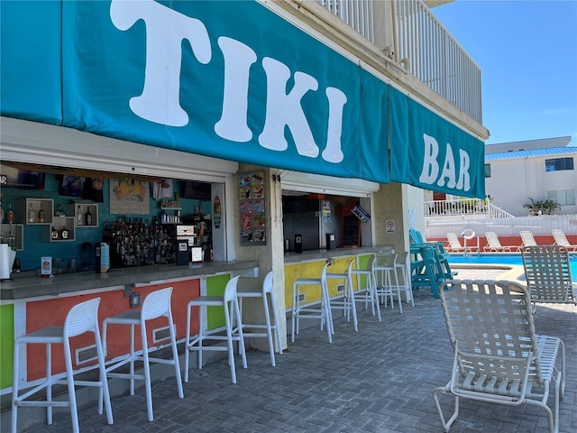 9980 Gulf Blvd Unit 408, Treasure Island, FL 33706 - view of patio / terrace with exterior bar and a community pool