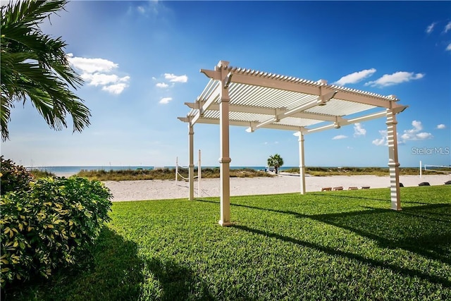 9980 Gulf Blvd Unit 408, Treasure Island, FL 33706 - view of grassy yard with volleyball court, a pergola, and view of water and beach