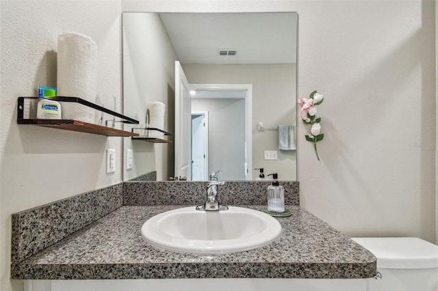 9437 Lemon Drop Loop, Sun City Center, FL 33573 - bathroom featuring vanity and toilet