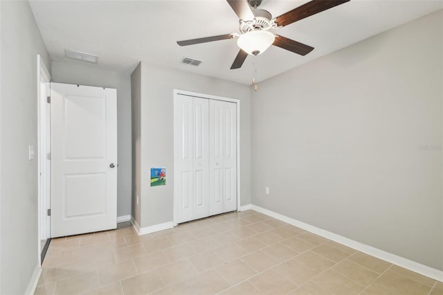 9437 Lemon Drop Loop, Sun City Center, FL 33573 - unfurnished bedroom featuring a closet, ceiling fan, and light tile patterned floors