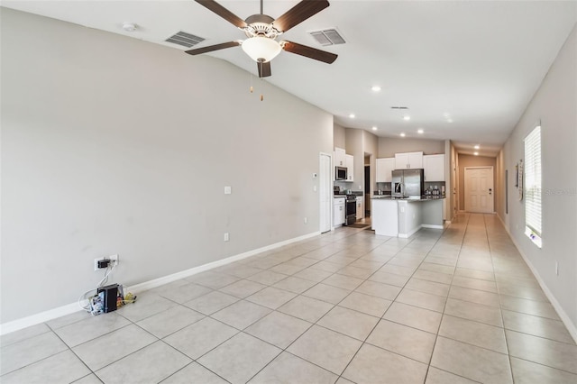 9437 Lemon Drop Loop, Sun City Center, FL 33573 - unfurnished living room with vaulted ceiling, a ceiling fan, light tile patterned floors, and recessed lighting
