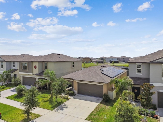 9437 Lemon Drop Loop, Sun City Center, FL 33573 - view of front of property with stucco siding, a residential view, concrete driveway, an attached garage, and solar panels