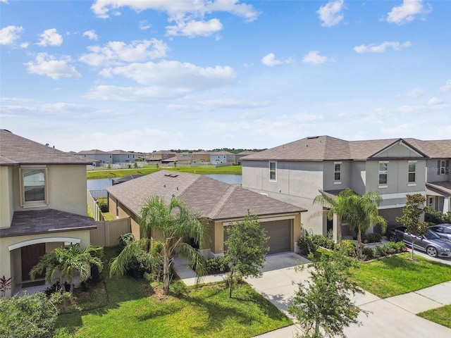9437 Lemon Drop Loop, Sun City Center, FL 33573 - view of front facade featuring a residential view, stucco siding, concrete driveway, and an attached garage
