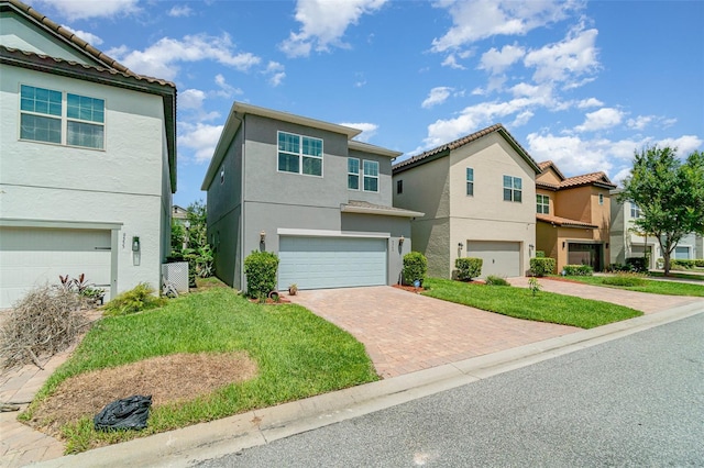 9349 Mira Valle Ln, Winter Garden, FL 34787 - view of front of house with decorative driveway, a garage, stucco siding, and a residential view