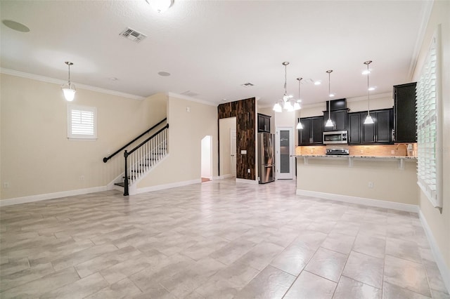 9349 Mira Valle Ln, Winter Garden, FL 34787 - kitchen with appliances with stainless steel finishes, open floor plan, crown molding, tasteful backsplash, and light stone countertops