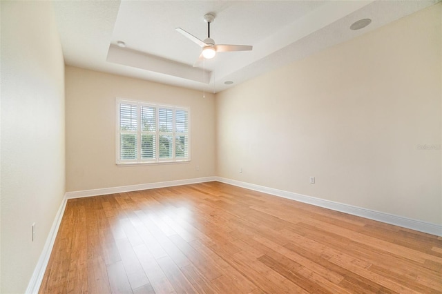 9349 Mira Valle Ln, Winter Garden, FL 34787 - empty room with a ceiling fan, light wood-type flooring, and a tray ceiling
