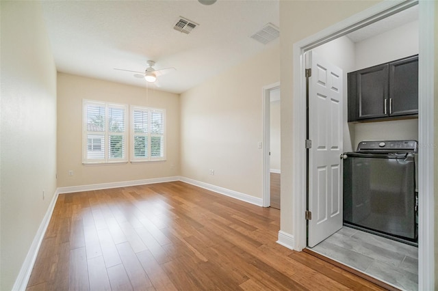 9349 Mira Valle Ln, Winter Garden, FL 34787 - spare room featuring washer / dryer, ceiling fan, and light wood-style floors