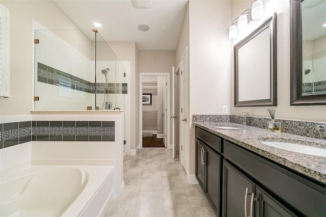 9349 Mira Valle Ln, Winter Garden, FL 34787 - bathroom featuring a shower stall, a bath, double vanity, and tile patterned flooring