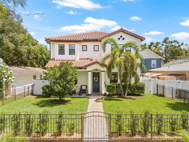 311 12th Ave N, Saint Petersburg, FL 33701 - mediterranean / spanish house featuring a gate, a tile roof, stucco siding, and a fenced front yard