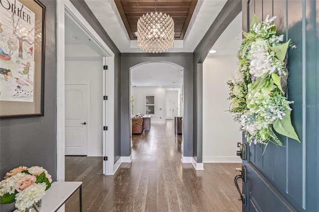 311 12th Ave N, Saint Petersburg, FL 33701 - foyer entrance featuring arched walkways, dark wood finished floors, a chandelier, a tray ceiling, and recessed lighting