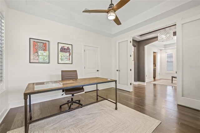 311 12th Ave N, Saint Petersburg, FL 33701 - home office with a tray ceiling, dark wood-style floors, a ceiling fan, and arched walkways