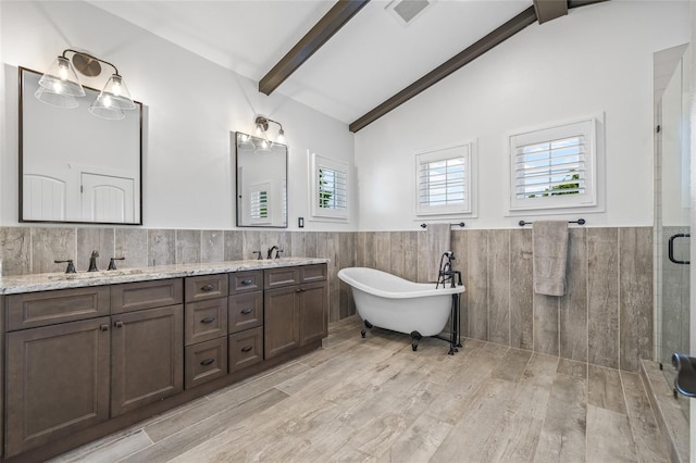 311 12th Ave N, Saint Petersburg, FL 33701 - full bath with tile walls, a wainscoted wall, double vanity, a shower stall, and a freestanding tub
