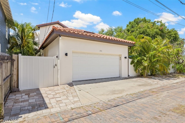 311 12th Ave N, Saint Petersburg, FL 33701 - garage featuring driveway and a gate