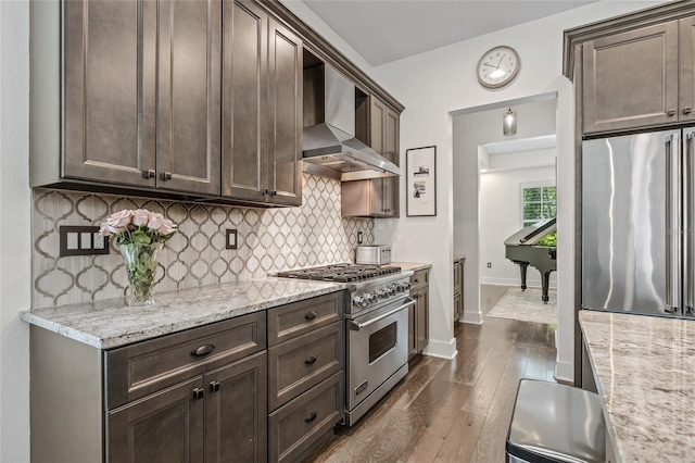 311 12th Ave N, Saint Petersburg, FL 33701 - kitchen with wall chimney exhaust hood, stainless steel appliances, dark brown cabinets, and backsplash