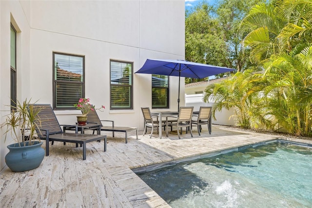 311 12th Ave N, Saint Petersburg, FL 33701 - back of house featuring stucco siding, a patio, an outdoor pool, and outdoor dining space