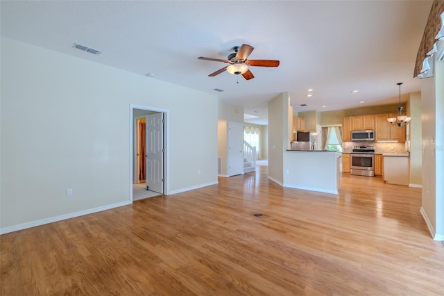5315 Cedarshake Ln, Valrico, FL 33596 - unfurnished living room with a chandelier, light wood-style floors, ceiling fan, and recessed lighting