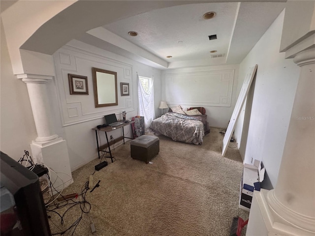 16027 Vine Cliff Ave, Hudson, FL 34667 - carpeted bedroom featuring ornate columns and a tray ceiling