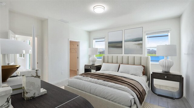 14424 59th Cir E, Bradenton, FL 34211 - bedroom with multiple windows, wood finished floors, and a spacious closet