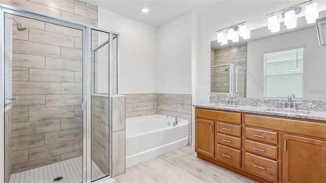 14424 59th Cir E, Bradenton, FL 34211 - full bathroom with a shower stall, double vanity, a bath, and wood finished floors