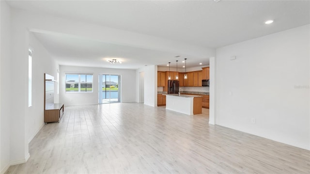 14424 59th Cir E, Bradenton, FL 34211 - unfurnished living room featuring recessed lighting and light wood-style floors