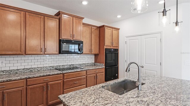 14424 59th Cir E, Bradenton, FL 34211 - kitchen with black appliances, tasteful backsplash, brown cabinets, light stone countertops, and pendant lighting