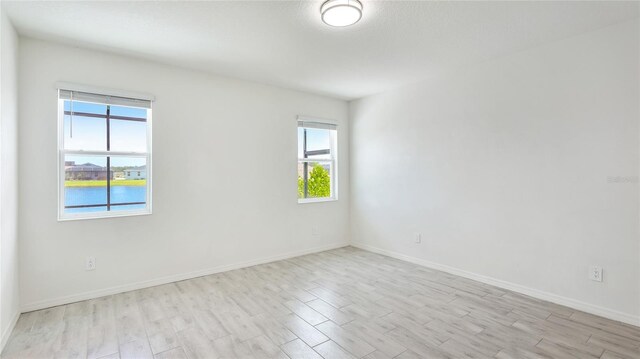 14424 59th Cir E, Bradenton, FL 34211 - unfurnished room with light wood-style flooring and plenty of natural light