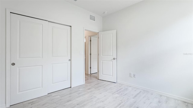 14424 59th Cir E, Bradenton, FL 34211 - unfurnished bedroom featuring a closet and light wood-style flooring