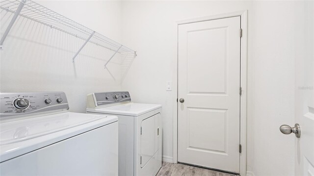 14424 59th Cir E, Bradenton, FL 34211 - washroom with washer and clothes dryer and light wood-type flooring