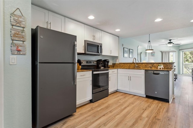 12000 Gulf Blvd Unit 403-S, Treasure Island, FL 33706 - kitchen featuring stainless steel appliances, a peninsula, white cabinetry, light wood-type flooring, and recessed lighting
