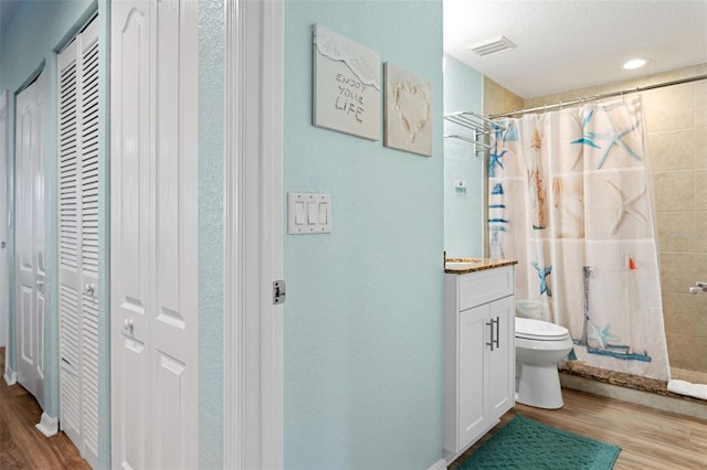 12000 Gulf Blvd Unit 403-S, Treasure Island, FL 33706 - bathroom with a closet, wood finished floors, a tile shower, and vanity