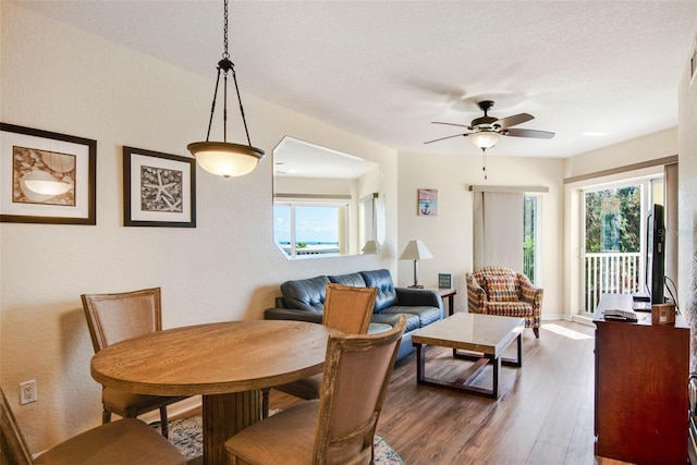 12000 Gulf Blvd Unit 403-S, Treasure Island, FL 33706 - dining room featuring wood finished floors, a ceiling fan, and a textured ceiling