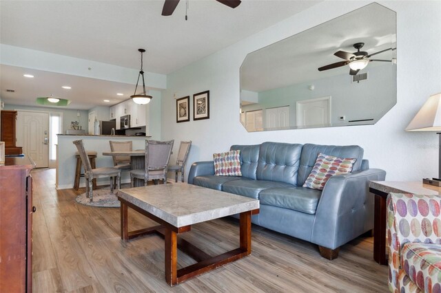 12000 Gulf Blvd Unit 403-S, Treasure Island, FL 33706 - living room featuring ceiling fan, light wood finished floors, and recessed lighting