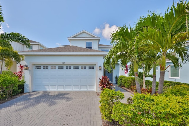 314 Blackrock Ln, Apollo Beach, FL 33572 - view of front of property featuring decorative driveway, an attached garage, and stucco siding