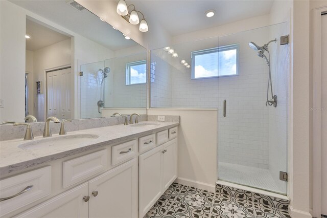 314 Blackrock Ln, Apollo Beach, FL 33572 - bathroom featuring a stall shower, tile patterned floors, double vanity, and healthy amount of natural light