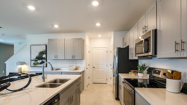 12474 Gust Ct, Hudson, FL 34669 - kitchen featuring stainless steel appliances, light countertops, gray cabinets, and recessed lighting