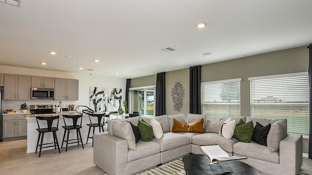 12474 Gust Ct, Hudson, FL 34669 - living area featuring healthy amount of natural light, light tile patterned floors, and recessed lighting