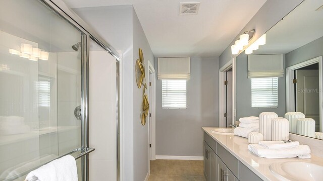 12474 Gust Ct, Hudson, FL 34669 - full bathroom with healthy amount of natural light, double vanity, a stall shower, and tile patterned flooring