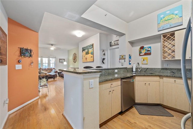 100 4th Ave S Unit 103, Saint Petersburg, FL 33701 - kitchen with stainless steel appliances, a peninsula, light wood-type flooring, light brown cabinets, and open floor plan