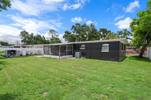1707 Windsor Way, Tampa, FL 33619 - back of property with a sunroom and a fenced backyard