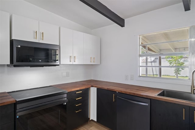 1707 Windsor Way, Tampa, FL 33619 - kitchen with butcher block countertops, electric range, dishwasher, beamed ceiling, and white cabinets