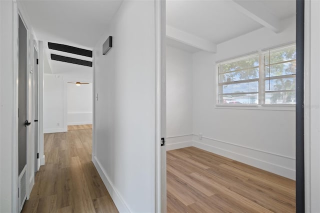 1707 Windsor Way, Tampa, FL 33619 - hallway with beam ceiling and light wood-style floors