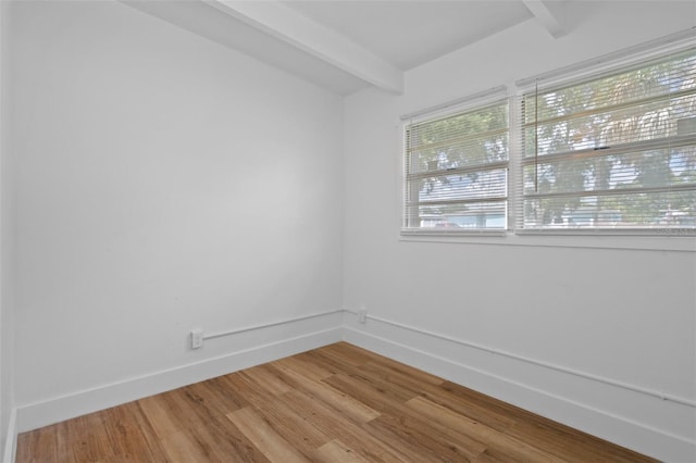 1707 Windsor Way, Tampa, FL 33619 - empty room featuring beam ceiling and wood finished floors