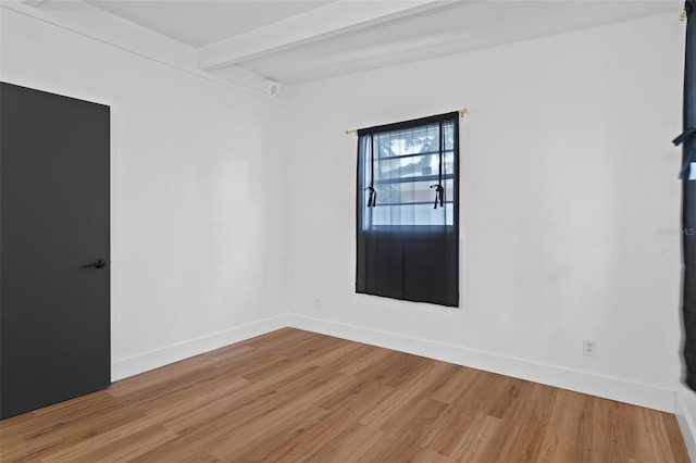 1707 Windsor Way, Tampa, FL 33619 - empty room featuring light wood finished floors and beamed ceiling