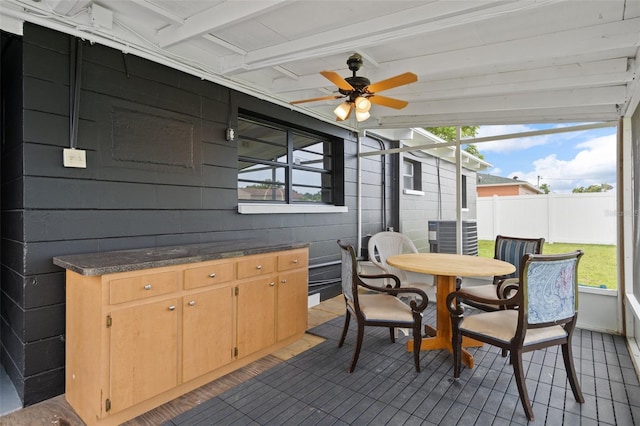 1707 Windsor Way, Tampa, FL 33619 - sunroom with ceiling fan, outdoor dining area, and beam ceiling