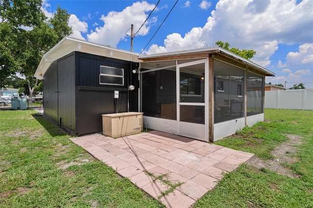 1707 Windsor Way, Tampa, FL 33619 - rear view of property with a sunroom and a patio