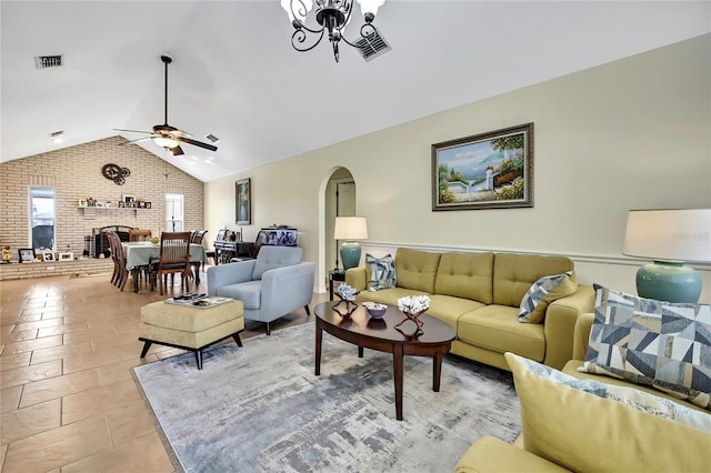 13814 Lavender Ave, Hudson, FL 34667 - living area with arched walkways, brick wall, ceiling fan, vaulted ceiling, and a fireplace
